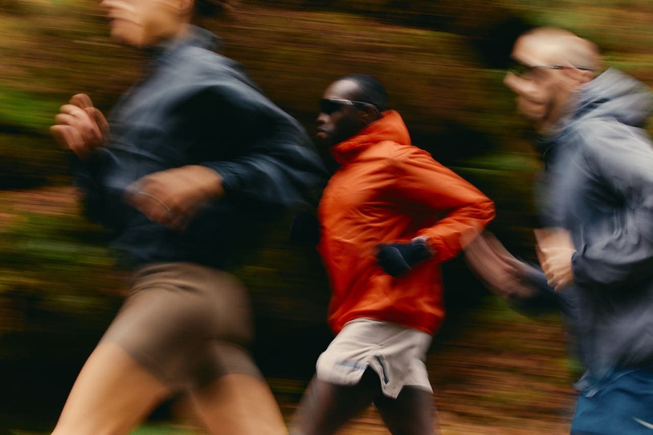 Two people running together on a forest trail